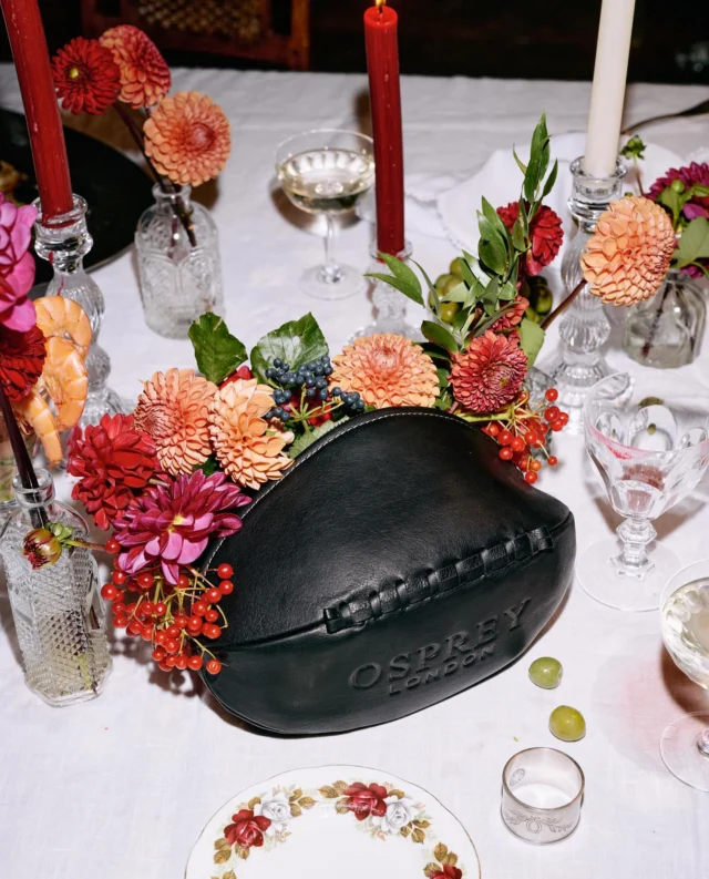 How amazing is this rugby ball washbag?! Florals had to be added obviously.  Festive fun with @ospreylondon #photoshoot #washbag #mensbag #leather #christmas #tablescapes #dahlias #editorial